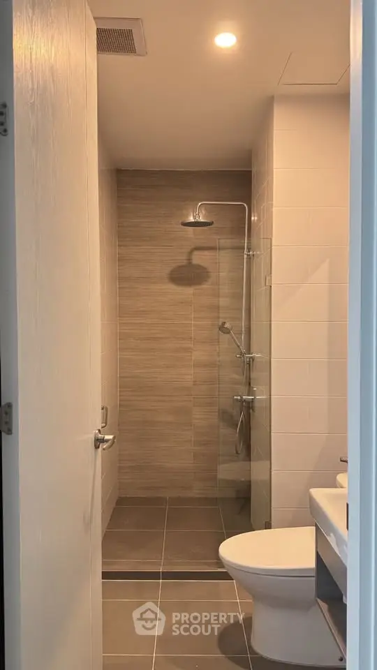 Modern bathroom with sleek shower and contemporary fixtures in a stylish apartment.