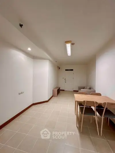 Spacious living room with modern furniture and elegant lighting, perfect for relaxation and entertaining guests.