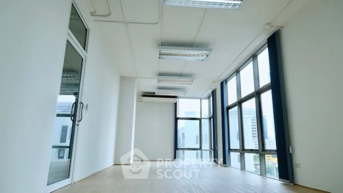 Spacious office space with large windows and city view, ideal for modern businesses.