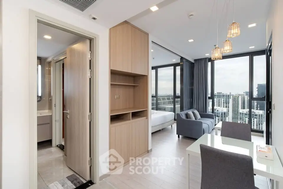 Modern open-plan living room with city view and elegant furnishings