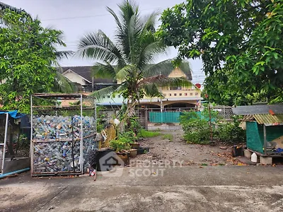 Spacious garden area with lush greenery and a view of residential buildings.