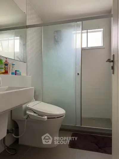 Modern bathroom with glass shower and bidet toilet in sleek design