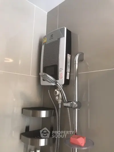 Modern bathroom with sleek shower unit and wall-mounted water heater.