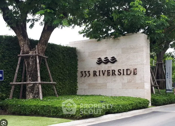 Elegant entrance of 333 Riverside with lush greenery and modern signage.