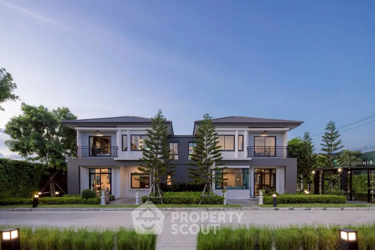 Stunning modern duplex with lush landscaping and elegant architecture, perfect for luxury living.