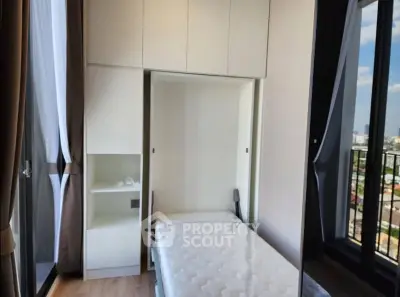 Modern bedroom with large windows and built-in storage, offering a bright and airy atmosphere.