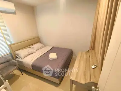 Cozy bedroom with modern furnishings and natural light, perfect for relaxation and comfort.