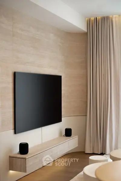 Modern living room with sleek TV setup and elegant curtains