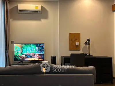 Modern living room with sleek furniture and wall-mounted air conditioner