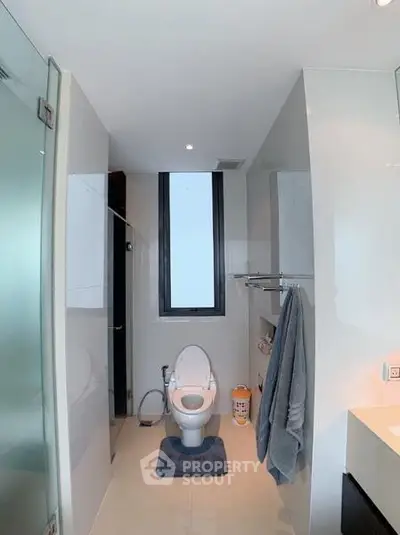Modern bathroom with sleek design and large window for natural light.