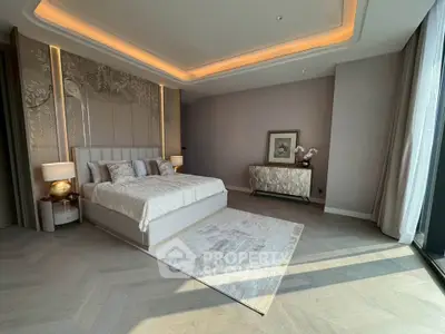 Luxurious modern bedroom with elegant decor and large windows offering natural light.