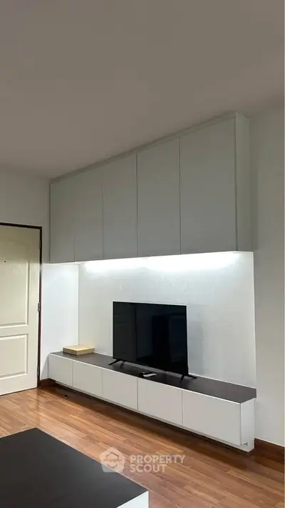 Modern living room with sleek TV unit and ambient lighting