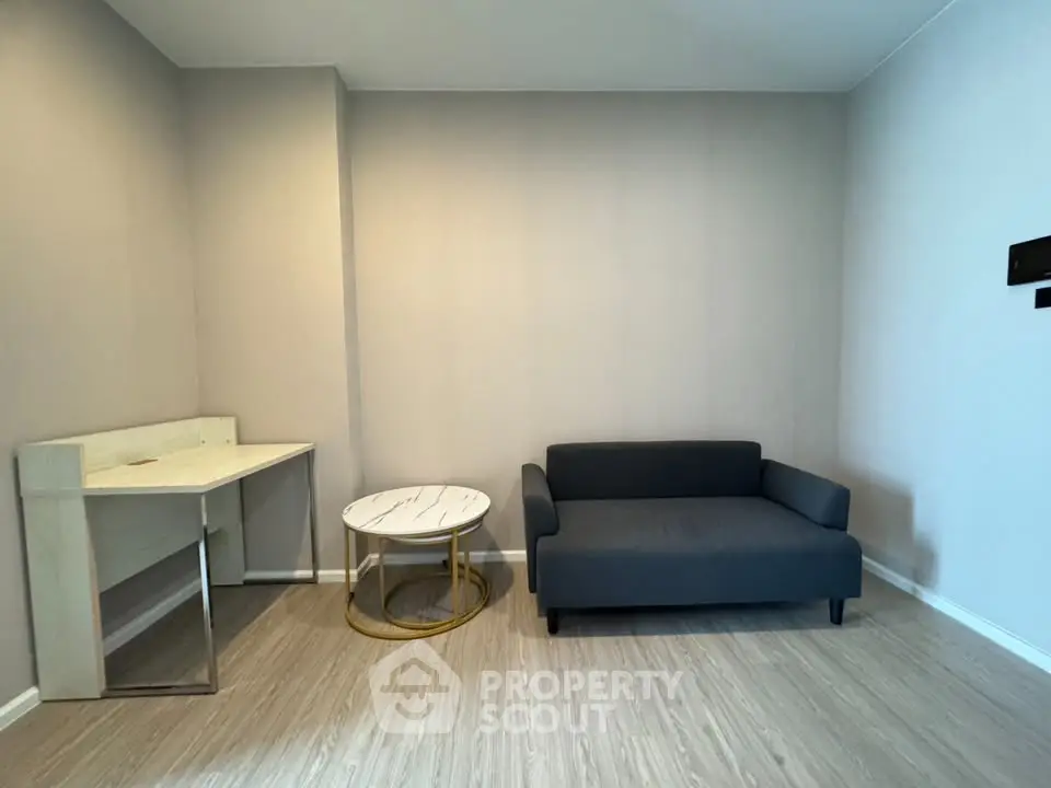 Modern minimalist living room with sleek sofa and stylish desk setup