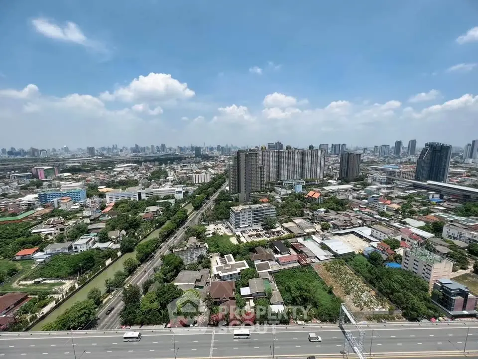 Stunning cityscape view showcasing urban skyline and residential areas under a clear blue sky.
