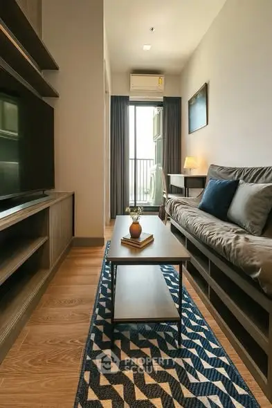 Modern living room with cozy sofa, stylish decor, and natural light from balcony.