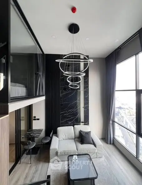 Modern loft apartment with stylish living room and mezzanine bedroom, featuring floor-to-ceiling windows and chic decor.
