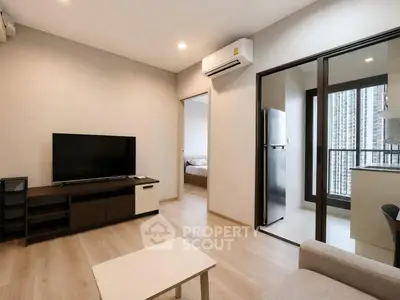 Modern living room with sleek furniture and balcony view in a stylish apartment.