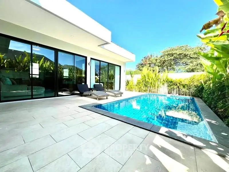 Luxurious modern villa with private pool and lush garden, perfect for relaxation and entertainment.