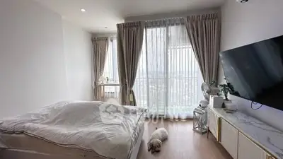 Bright and cozy bedroom with large windows and modern decor.