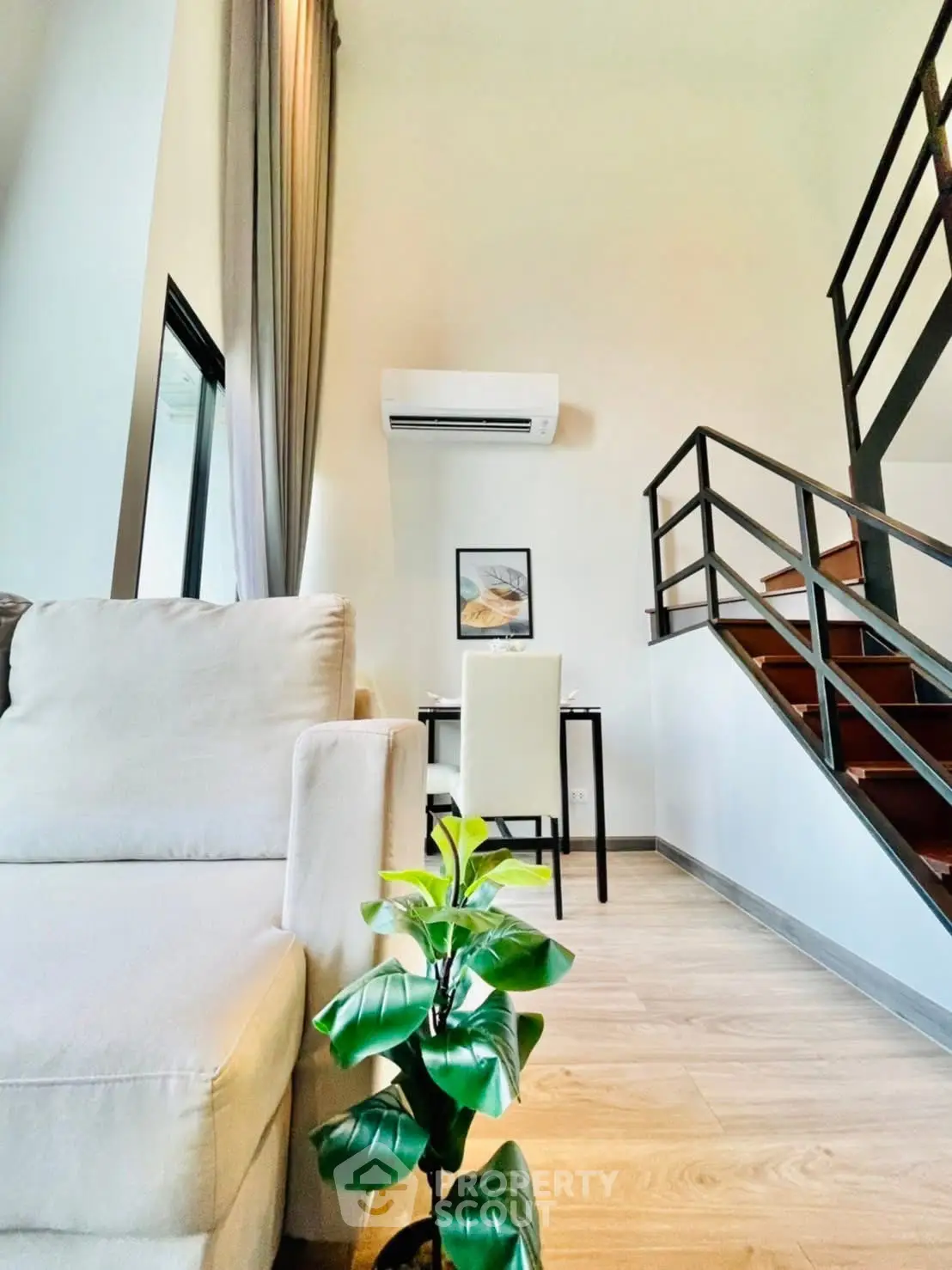 Modern duplex living room with stylish staircase and cozy seating area