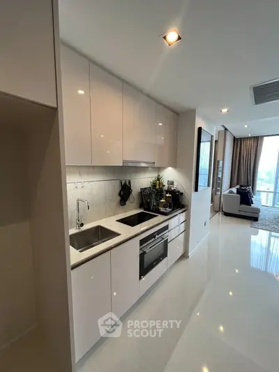 Modern kitchen with sleek cabinetry and integrated appliances in a stylish apartment.