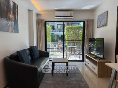 Modern living room with balcony view, sleek furniture, and natural light in a stylish apartment.