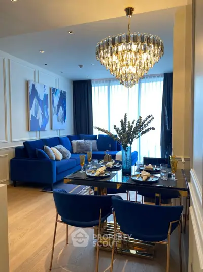 Luxurious living room with elegant chandelier and stylish blue decor