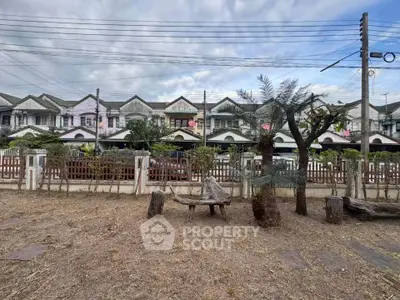 Charming townhouse row with unique facade and cozy front yard, perfect for family living.