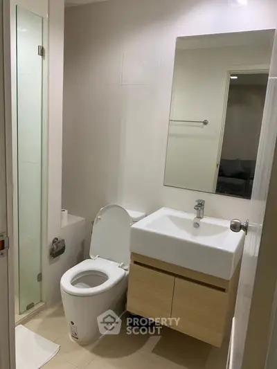 Modern bathroom with sleek fixtures and spacious shower in a contemporary home.