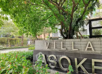 Luxurious Villa Asoke entrance surrounded by lush greenery, offering a serene and elegant living environment.