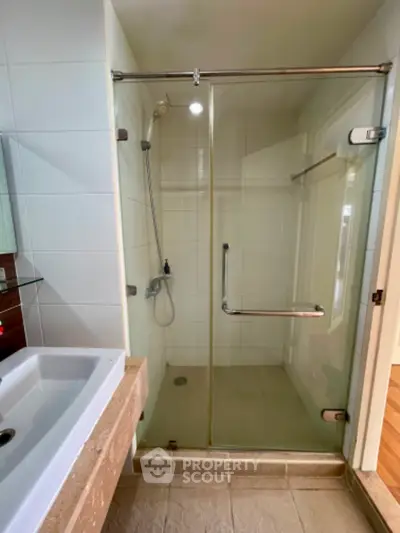 Modern bathroom with glass shower enclosure and sleek sink design