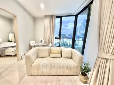 Modern living room with elegant sofa and city view from large windows