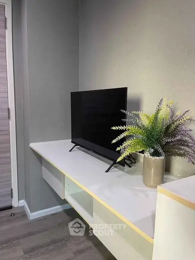 Modern minimalist living room with sleek TV and stylish decor