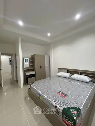 Modern bedroom with sleek furniture and ample storage space