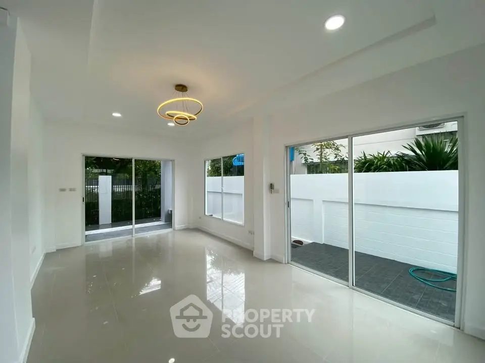 Spacious modern living room with large windows and garden view