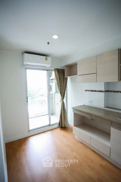 Modern kitchen with open layout and balcony view in a bright apartment