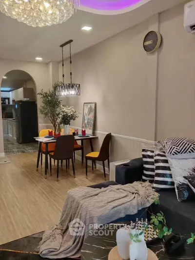 Stylish living room with modern dining area and elegant lighting, perfect for cozy gatherings.