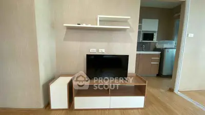 Modern living room with sleek TV stand and open kitchen layout