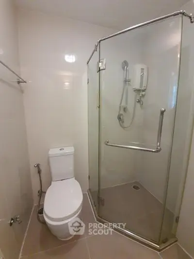 Modern bathroom with glass shower enclosure and sleek fixtures