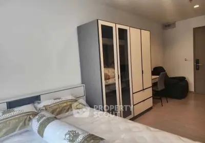 Modern bedroom with stylish wardrobe and cozy seating area