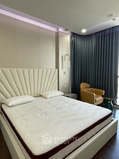 Luxurious bedroom with elegant bed and cozy seating area, perfect for relaxation and comfort.