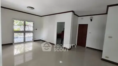 Spacious empty living room with large windows and glossy tiled floor