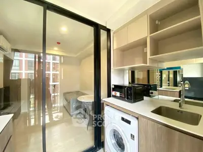 Modern kitchen with washing machine and open layout in a bright apartment