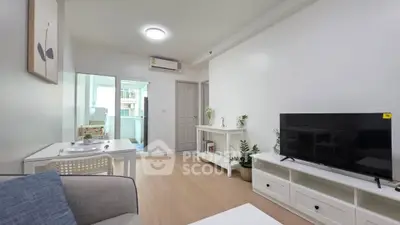 Modern living room with sleek furniture and natural light in a stylish apartment.