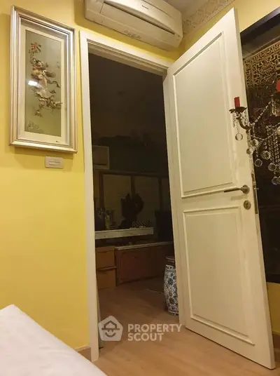 Charming interior with open door revealing cozy room and elegant decor, perfect for a warm home ambiance.