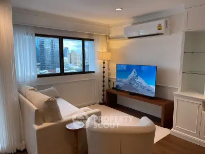 Chic living room with city view, modern furniture, and wall-mounted TV in a high-rise apartment.