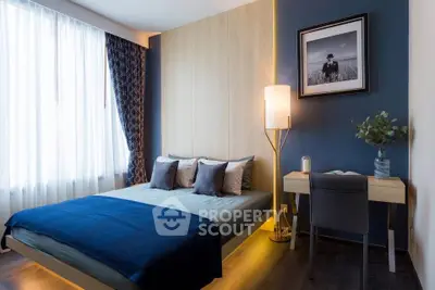 Modern bedroom with stylish decor, featuring a cozy bed, elegant lighting, and a functional study desk.