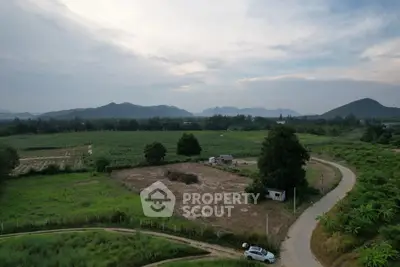 Scenic aerial view of expansive rural land with mountains in the background, ideal for development.