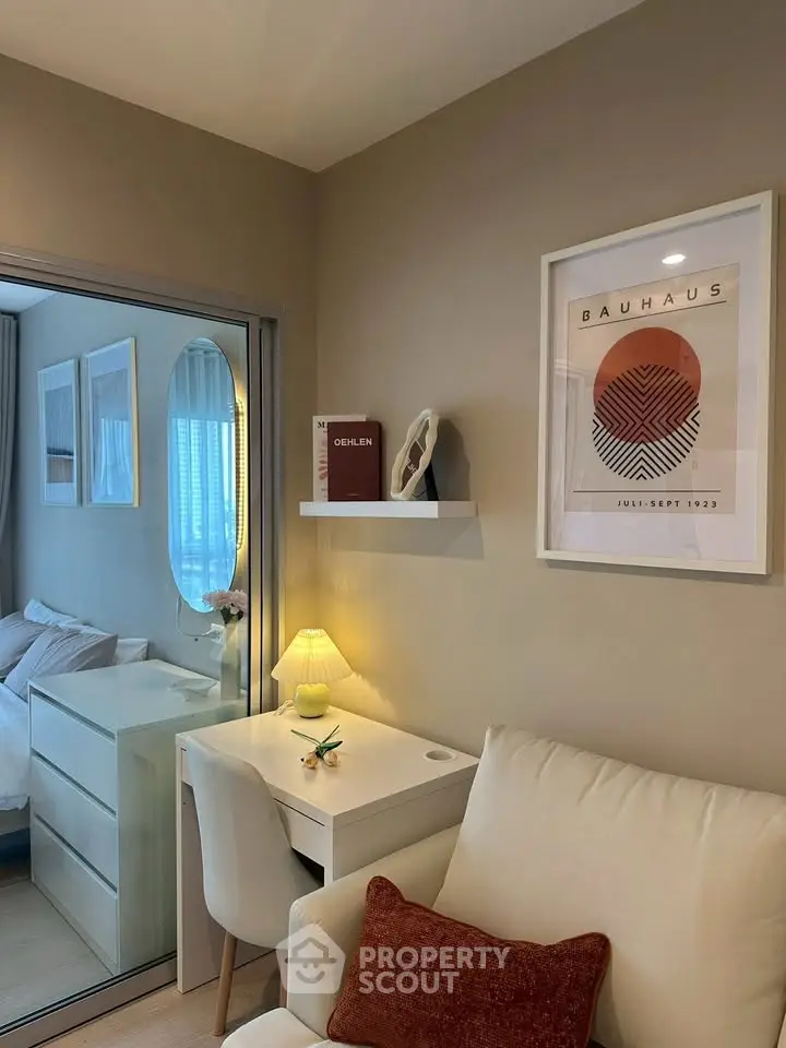Chic and cozy study nook with modern decor and natural light in a stylish apartment.