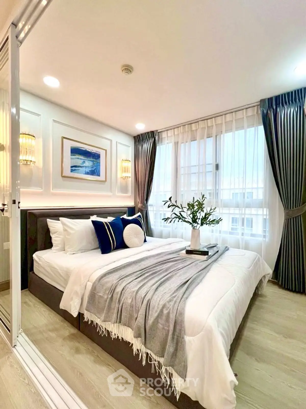 Elegant bedroom with modern decor and large windows for natural light